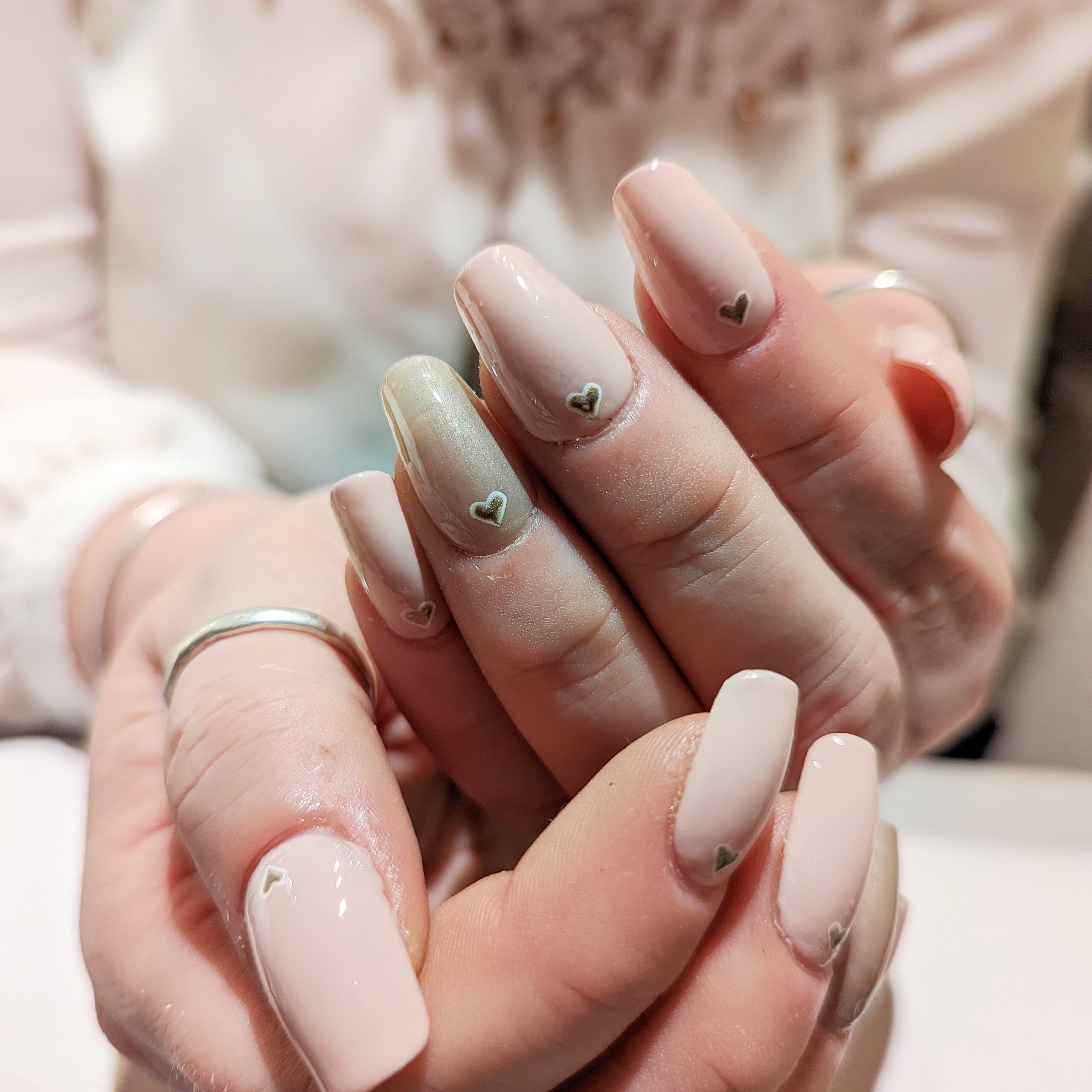 Gel X extensions in nude colours, with hand-painted hearts at the bed of each nail. Ginger Harmony - Nourishing vegan beauty in the heart of Oakham