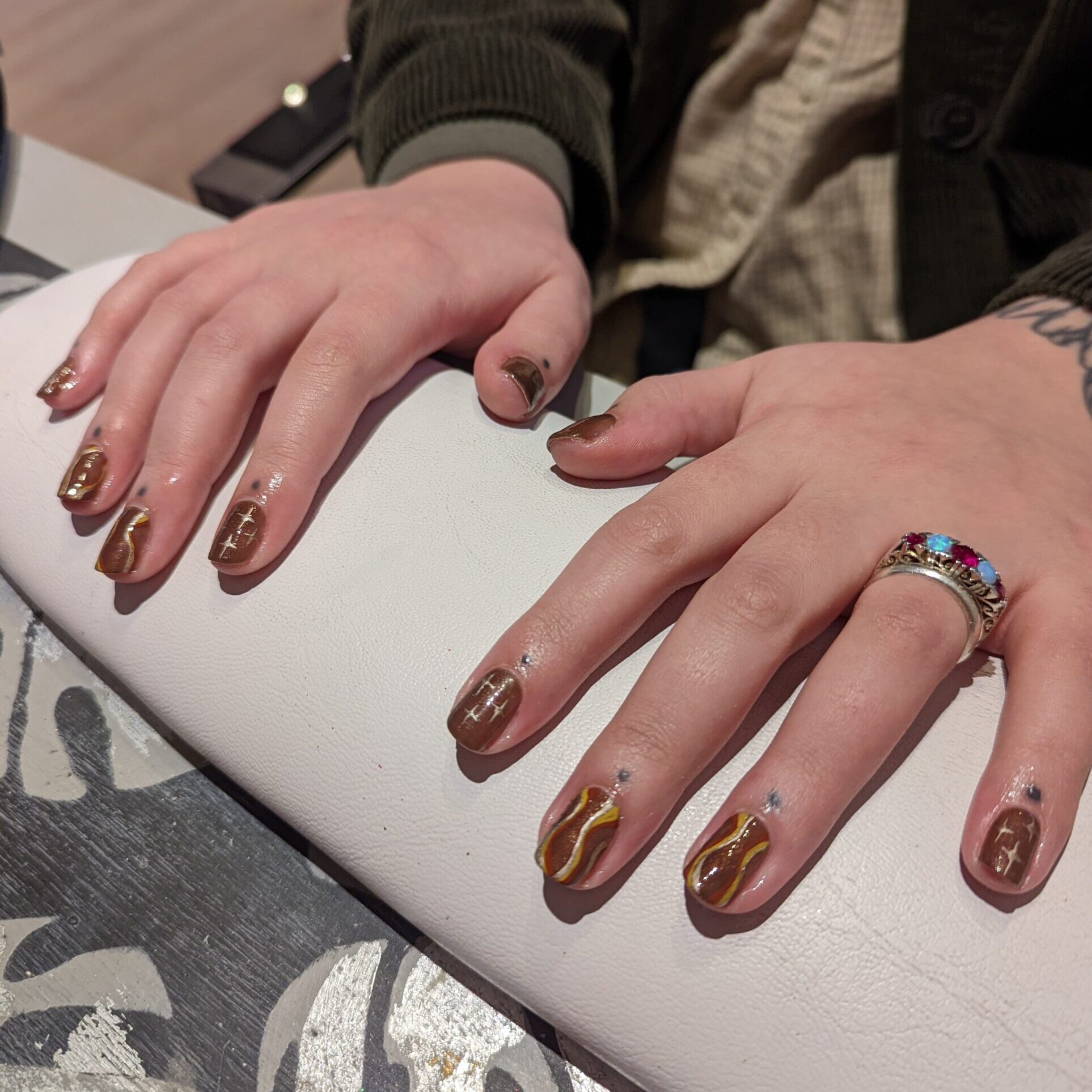 Brown gel nails with caramel swirls